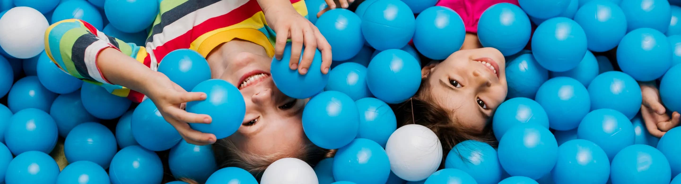 Kids swimming in plastic balls