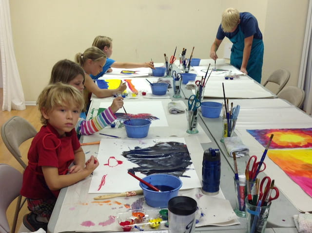 a group of children painting