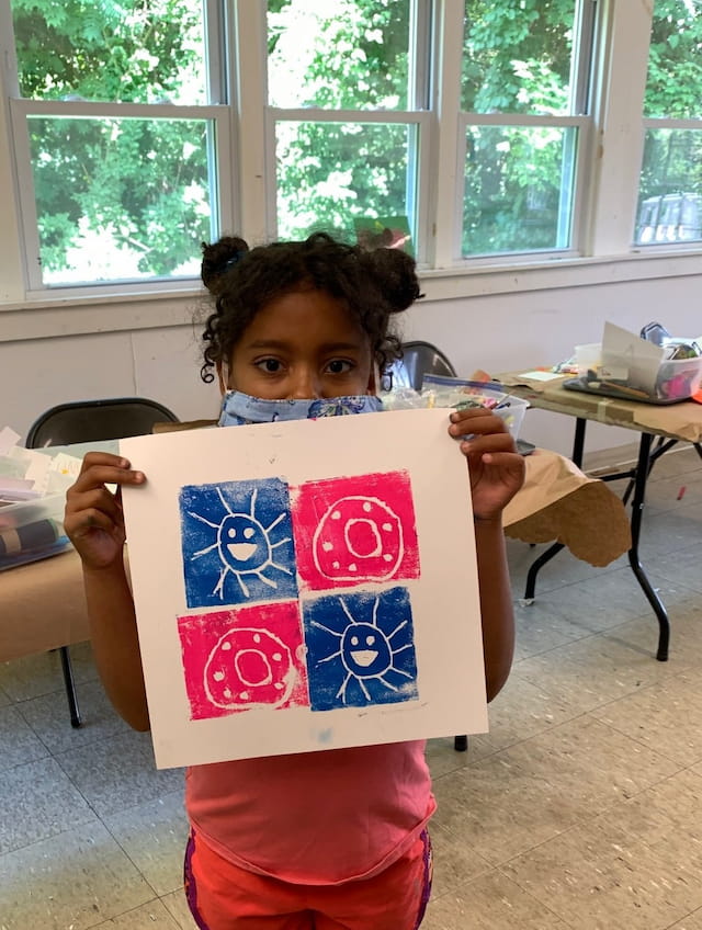 a child holding a sign