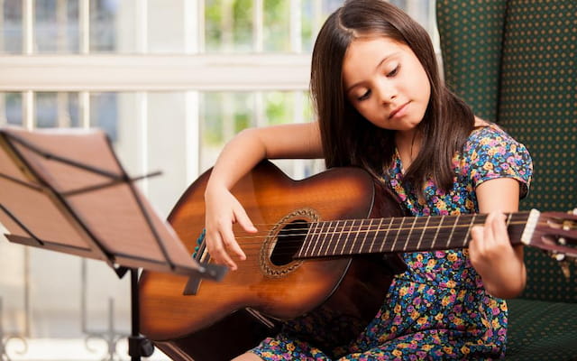 a woman playing a guitar