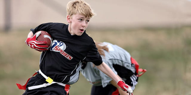 a boy holding a football