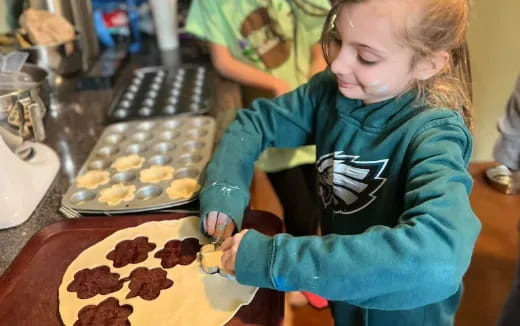 a girl making a cookie