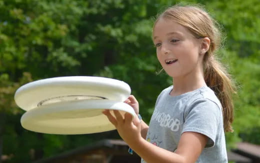 a girl holding a frisbee