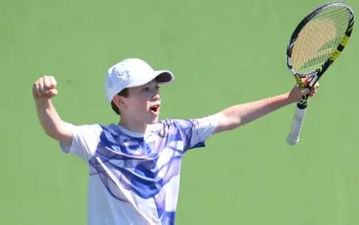 a boy playing tennis