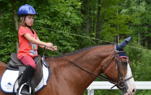 a girl riding a horse