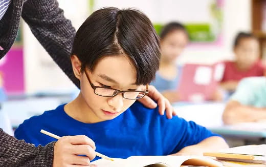 a young boy wearing glasses