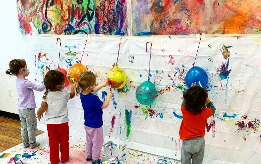 a group of children painting