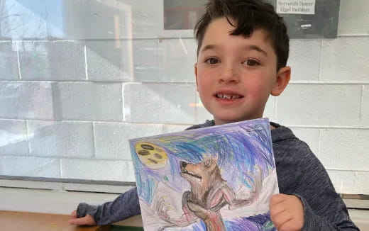 a boy holding a book