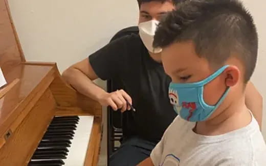 a boy playing a piano