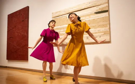 two women in dresses dancing