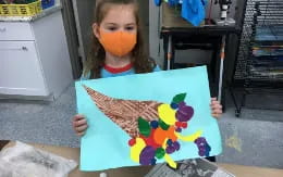 a child holding a drawing