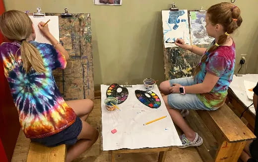 a couple of girls painting