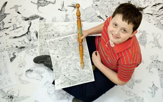 a boy holding a pencil