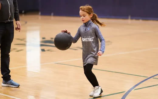 a girl holding a ball