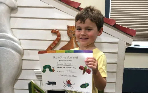 a boy holding a sign