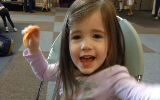 a girl eating a donut