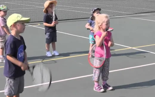 kids playing tennis on court