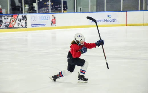 a young girl playing hockey