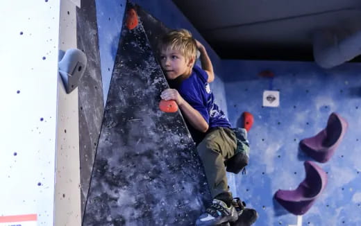 a boy climbing a wall