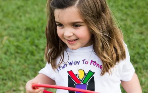 a girl holding a toy