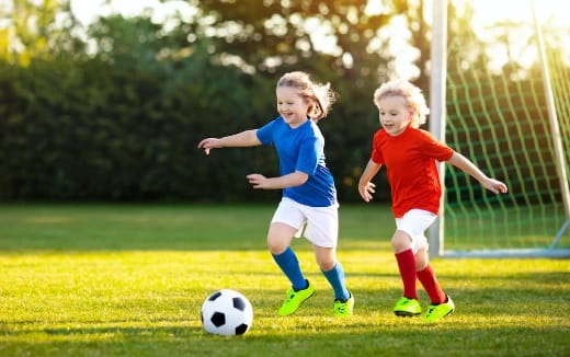 two kids playing football