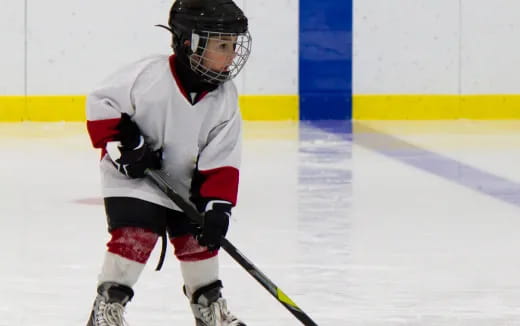 a young boy playing hockey