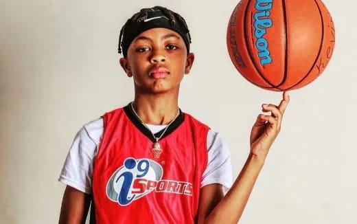 a boy holding a basketball