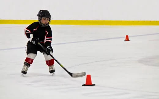 a young boy playing hockey