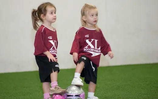 two girls wearing football uniforms