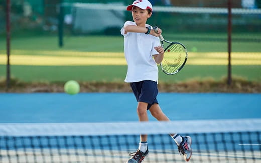 a boy playing tennis