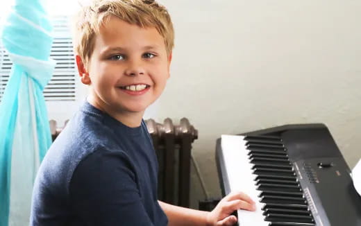 a boy playing a piano