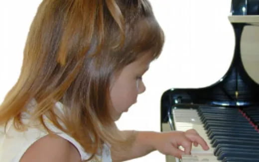 a woman playing a piano