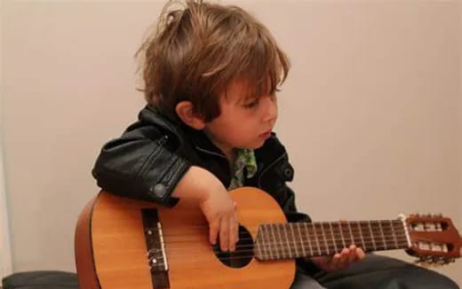 a boy playing a guitar