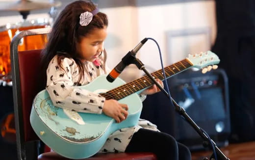 a girl playing a guitar