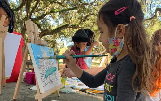 a group of children painting