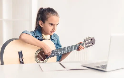 a young girl playing guitar