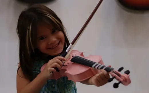 a girl playing a violin