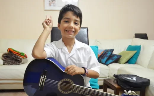 a boy holding a guitar