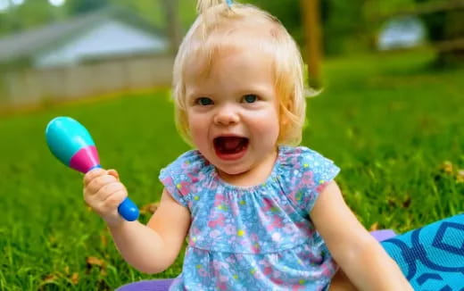 a baby holding a toy