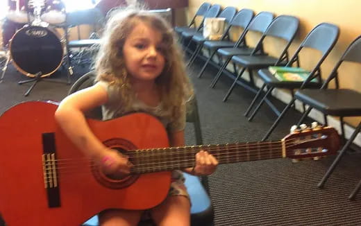 a girl playing a guitar