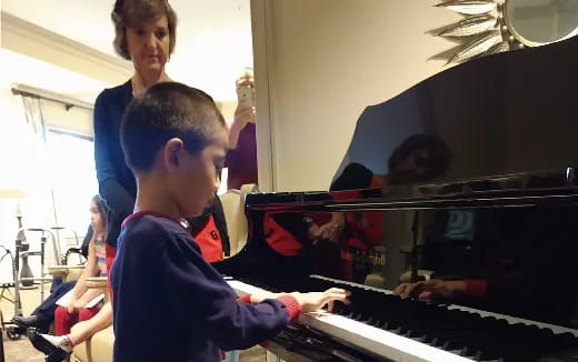 a boy playing a piano