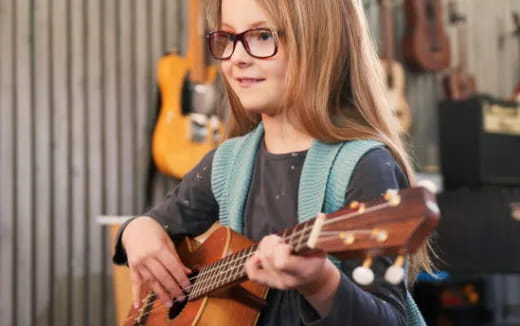 a woman playing a guitar