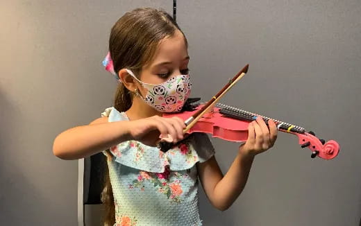 a girl playing a violin