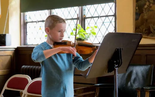 a boy playing a piano