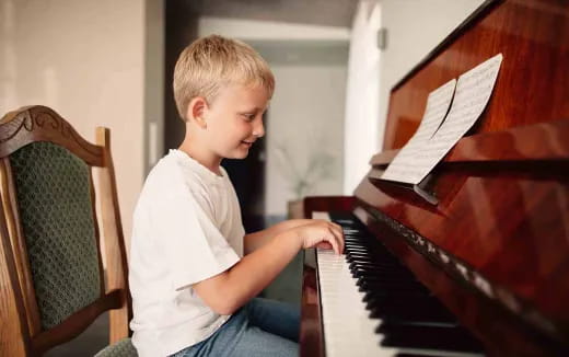 a boy playing a piano