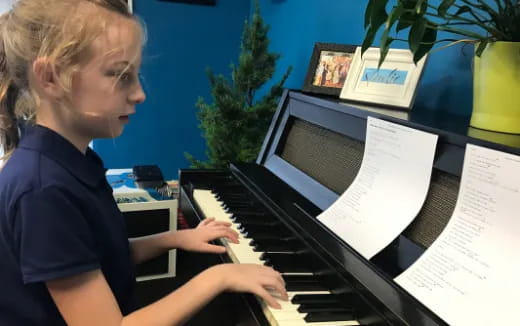 a girl playing a piano