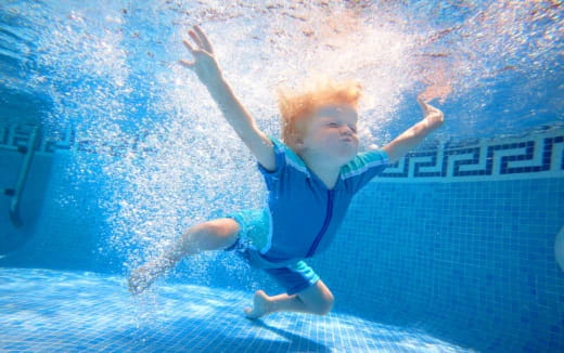 a boy jumping into water