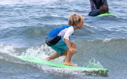 a kid riding a surfboard