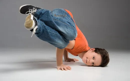 a boy doing a handstand