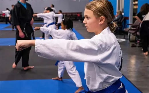 a young girl practicing karate